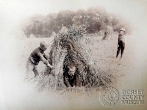 Children playing in Straw Bundles, Winterborne Monkton - © Dorset County Museum