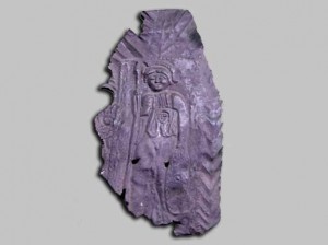 The bronze plaque of Minerva found on the Temple site of Maiden Castle now on display in the Dorset County Museum