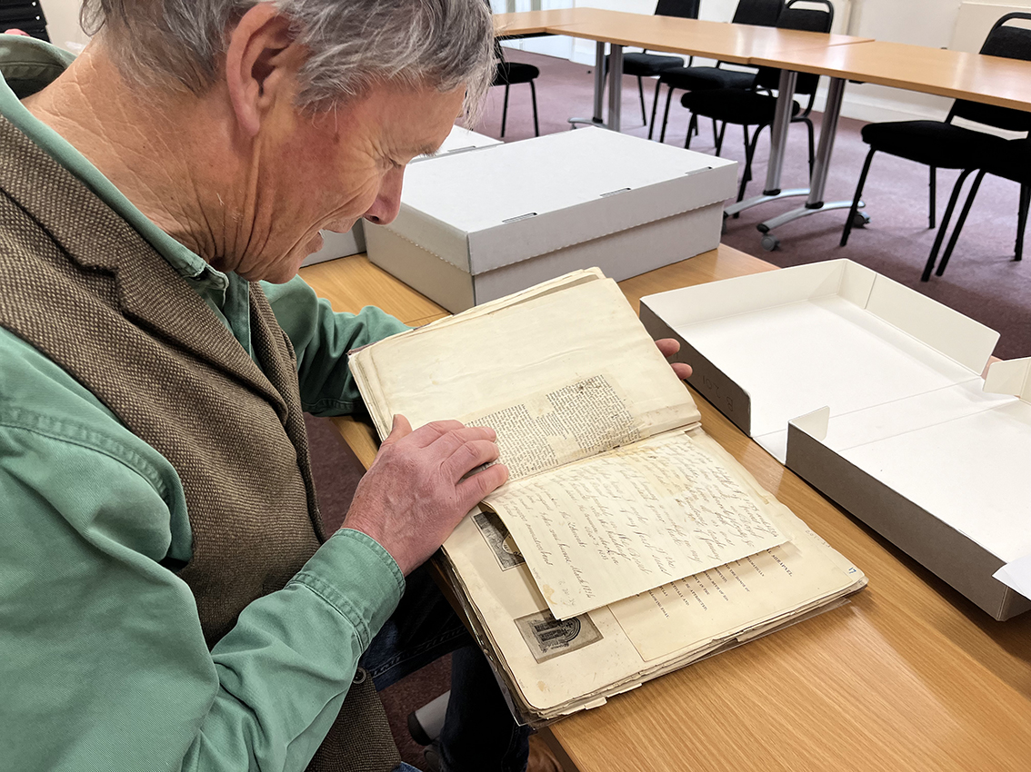  Tim Laycock, looking through the many scrapbooks kept by William Barnes.